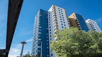 A tall building with a blue sky in the background at Skye at Belltown Apartments, Seattle, Washington